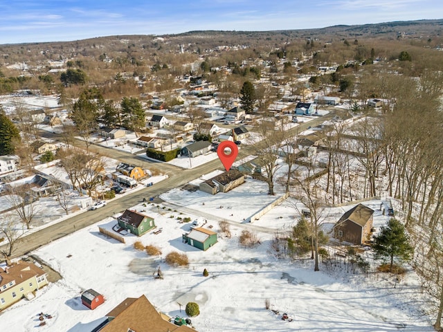 snowy aerial view featuring a residential view