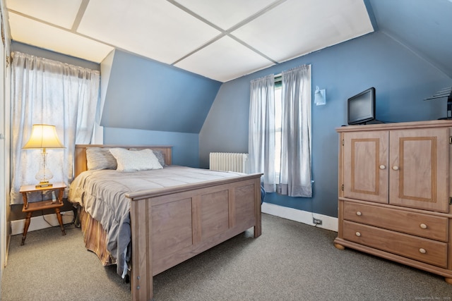 carpeted bedroom with lofted ceiling, radiator heating unit, and baseboards