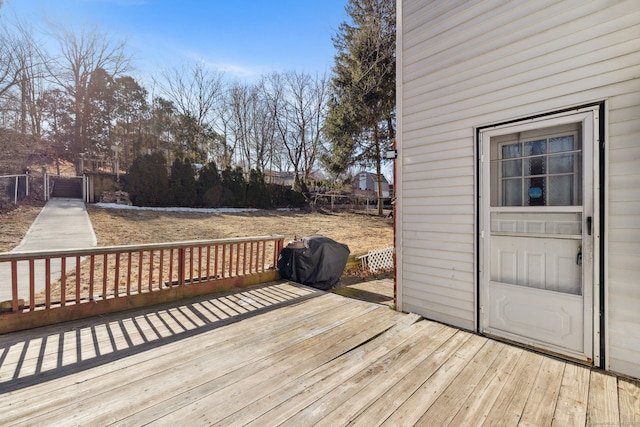 wooden terrace featuring area for grilling and fence