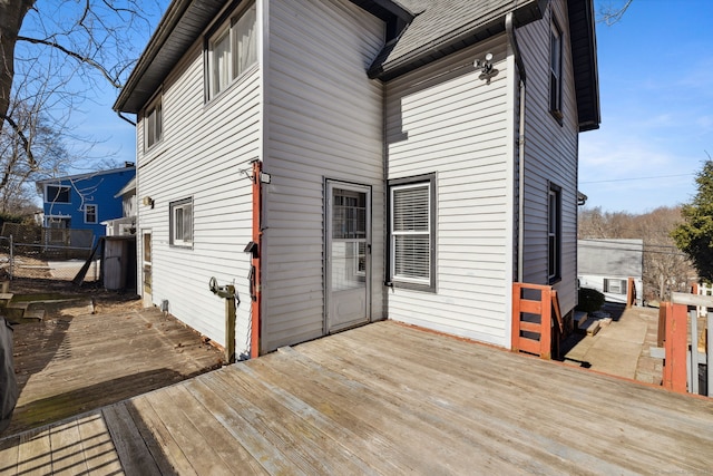 wooden terrace featuring entry steps and fence