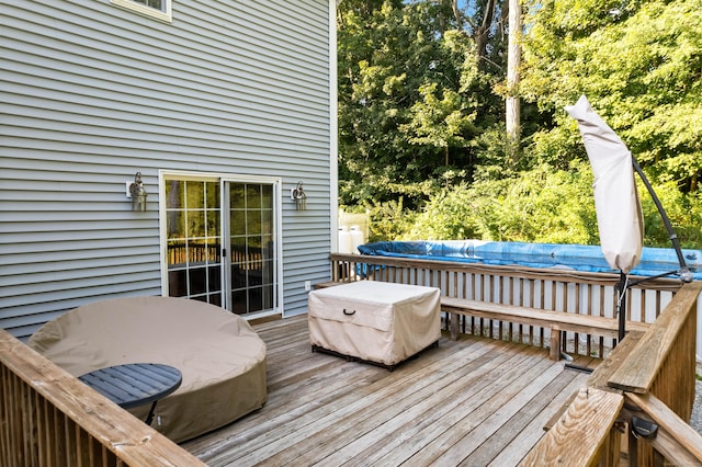 deck featuring a covered pool