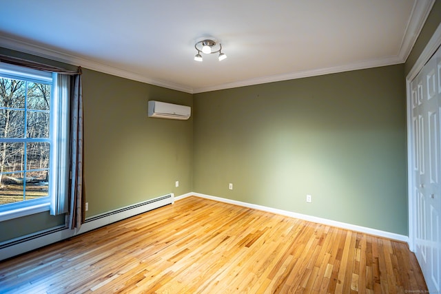 empty room featuring ornamental molding, a baseboard radiator, a wall unit AC, and hardwood / wood-style floors