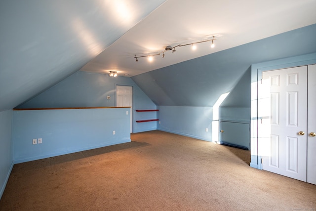 additional living space with carpet floors, baseboards, and lofted ceiling