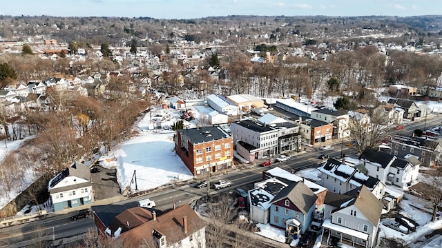 snowy aerial view with a residential view