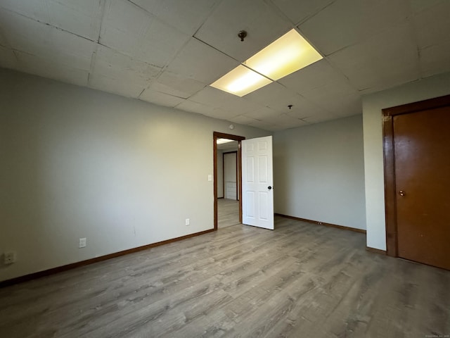 unfurnished room with light wood-style flooring and baseboards