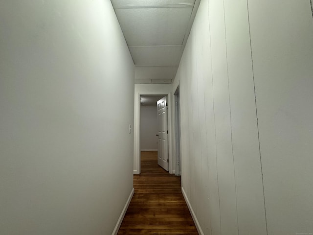 hall with baseboards and dark wood-style flooring