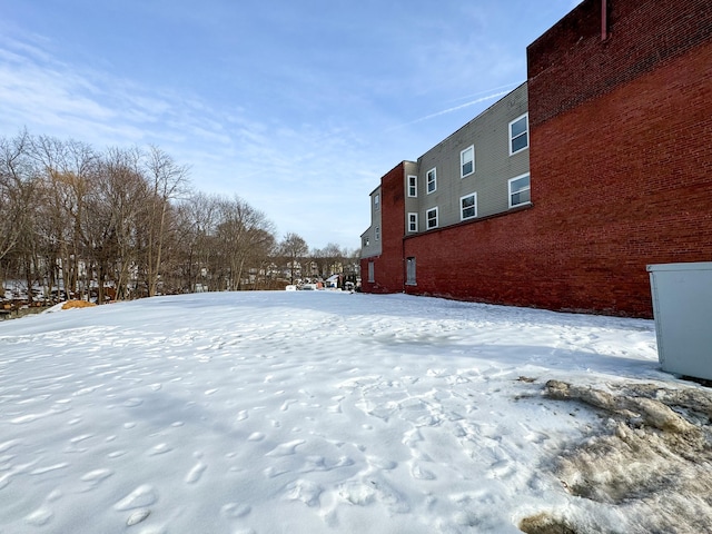 view of yard layered in snow