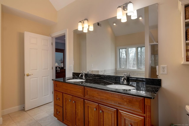 bathroom featuring lofted ceiling, double vanity, a sink, and tile patterned floors