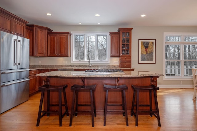 kitchen with a healthy amount of sunlight, a kitchen bar, and stainless steel appliances