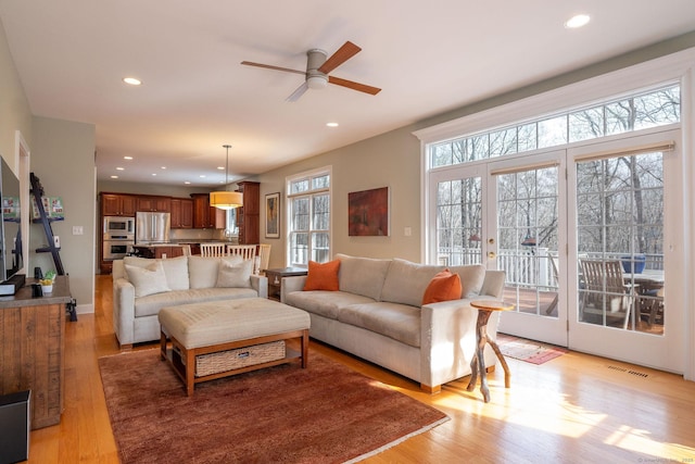 living area featuring french doors, recessed lighting, visible vents, a ceiling fan, and light wood-type flooring