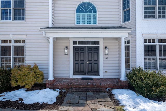 view of snow covered property entrance