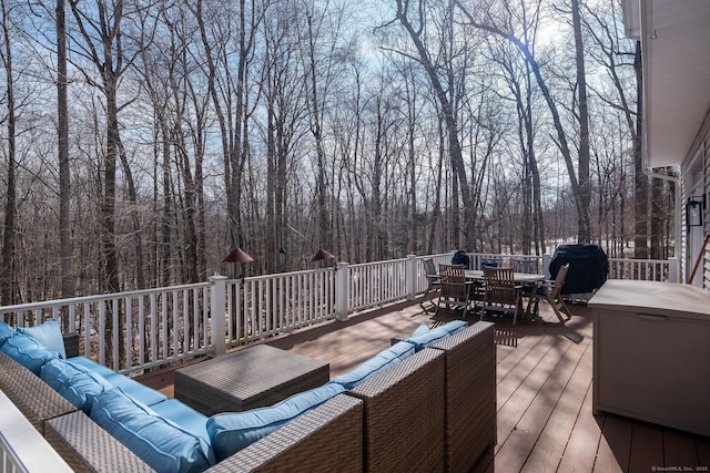 wooden terrace with outdoor dining area and an outdoor hangout area