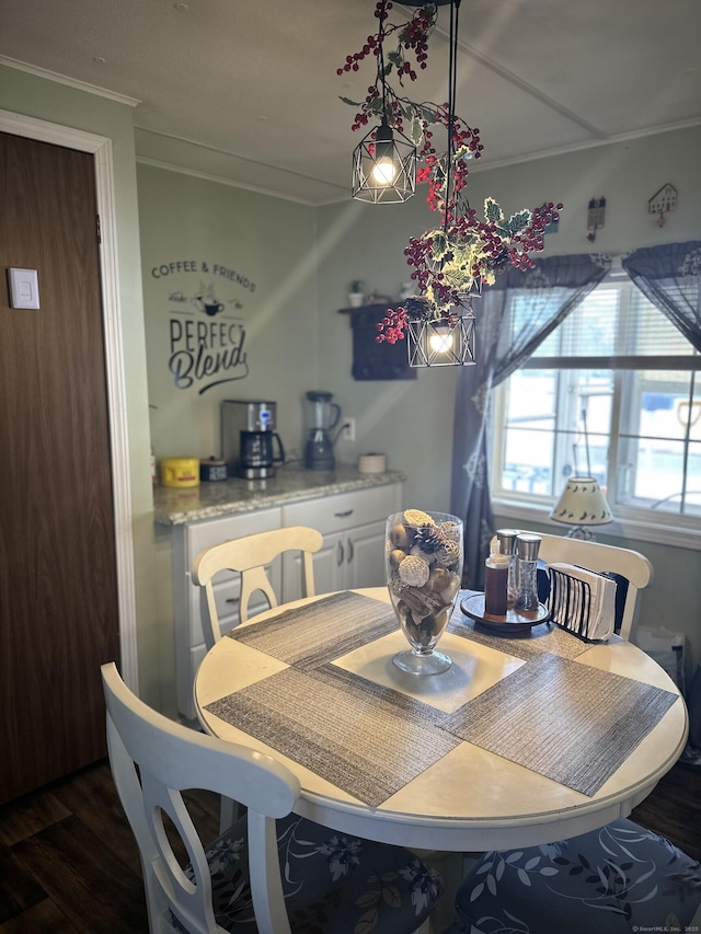 dining room with ornamental molding and dark wood-type flooring