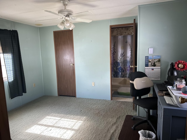 carpeted home office with a ceiling fan