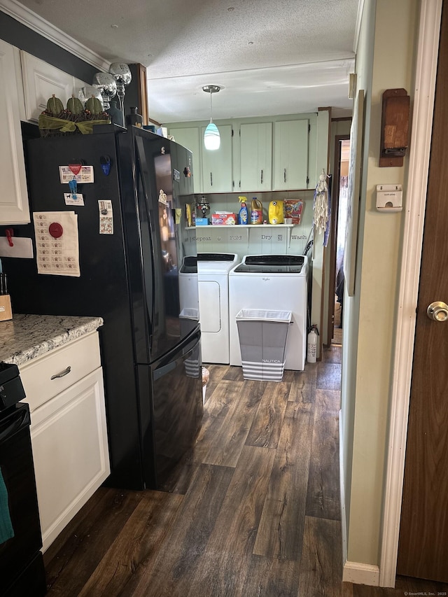 kitchen featuring range, dark wood finished floors, washing machine and clothes dryer, light countertops, and a textured ceiling