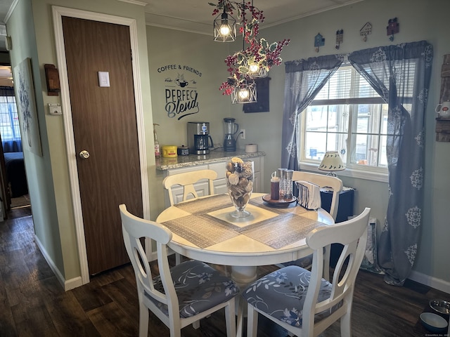 dining area with baseboards, dark wood-type flooring, and crown molding