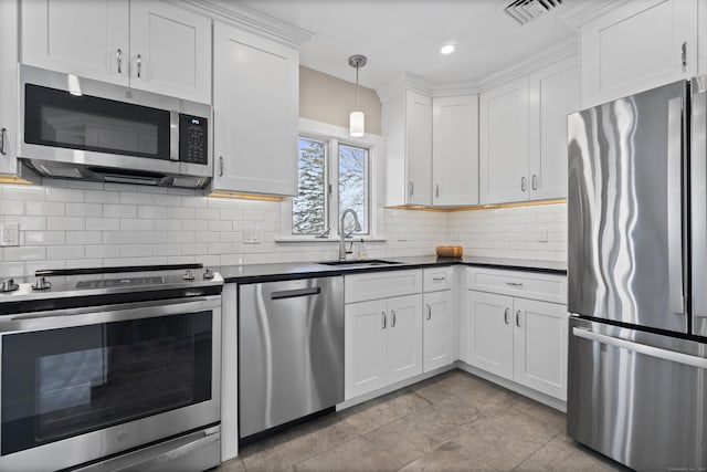 kitchen with visible vents, white cabinets, dark countertops, appliances with stainless steel finishes, and a sink