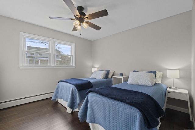 bedroom with dark wood-style floors, a baseboard heating unit, a ceiling fan, and baseboards