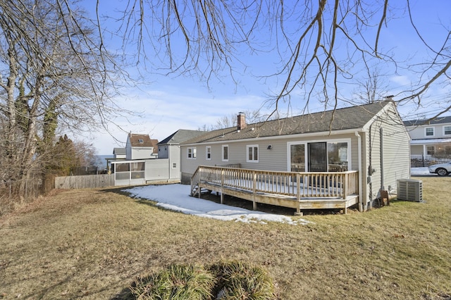 back of property featuring a lawn, a chimney, fence, a deck, and central air condition unit