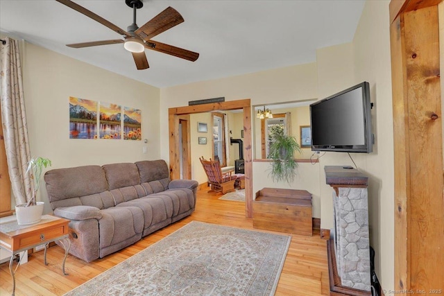 living room featuring ceiling fan and light wood finished floors