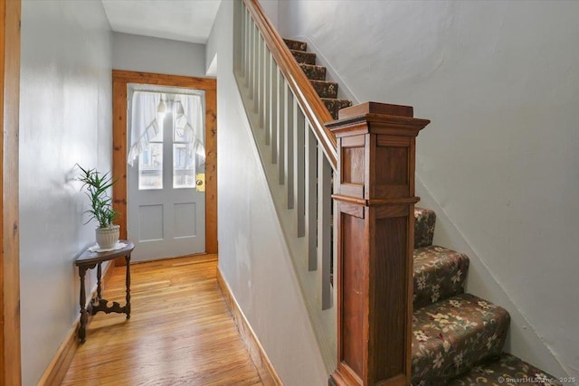 staircase with wood finished floors and baseboards