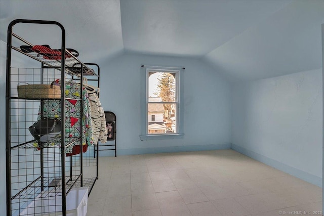 bonus room featuring lofted ceiling and baseboards