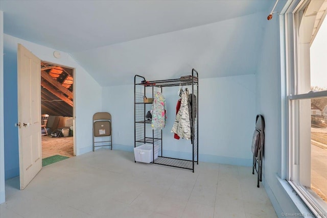 bedroom with baseboards and vaulted ceiling