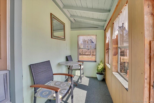 sunroom / solarium with vaulted ceiling with beams