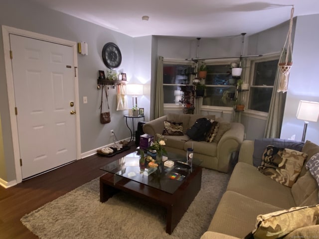 living area with wood finished floors and baseboards