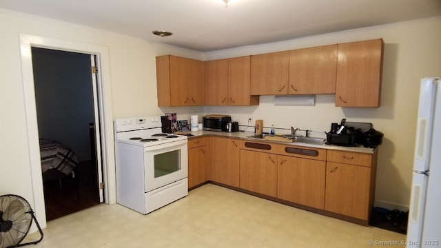 kitchen featuring white appliances, crown molding, light floors, and a sink