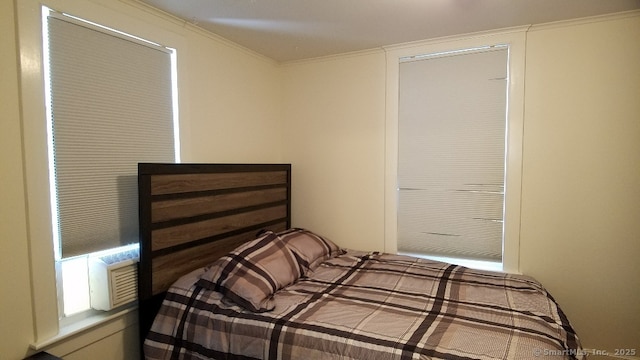 bedroom with cooling unit and crown molding