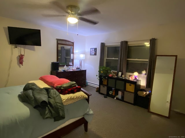 carpeted bedroom with baseboard heating and a ceiling fan