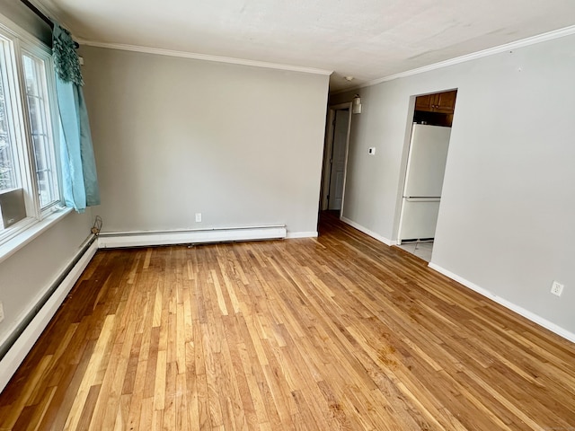 unfurnished room featuring light wood finished floors, baseboards, ornamental molding, baseboard heating, and a baseboard heating unit