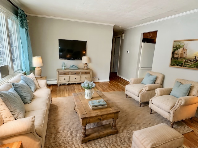 living room with light wood-type flooring, a baseboard radiator, baseboards, and crown molding