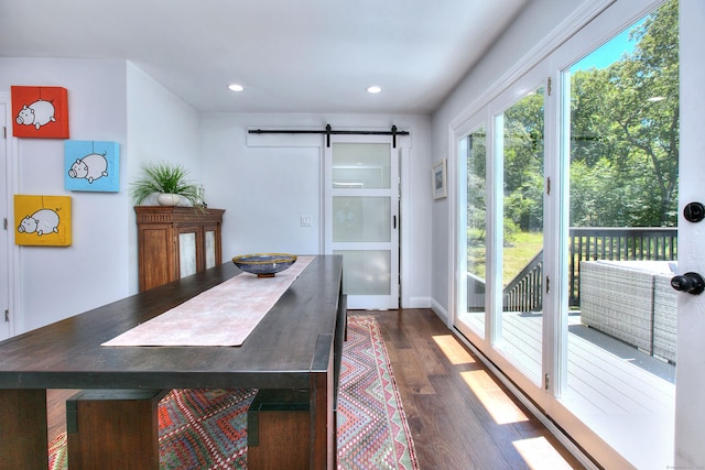 dining space featuring dark wood-style floors, a barn door, a wealth of natural light, and recessed lighting