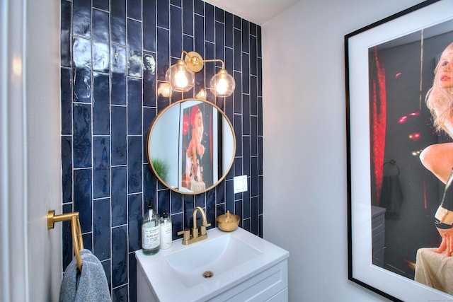 bathroom with tasteful backsplash, tile walls, and vanity