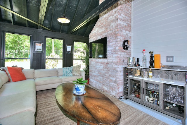 living room featuring vaulted ceiling with beams, wood walls, and tile patterned floors