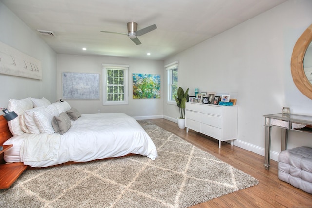 bedroom featuring recessed lighting, visible vents, ceiling fan, wood finished floors, and baseboards