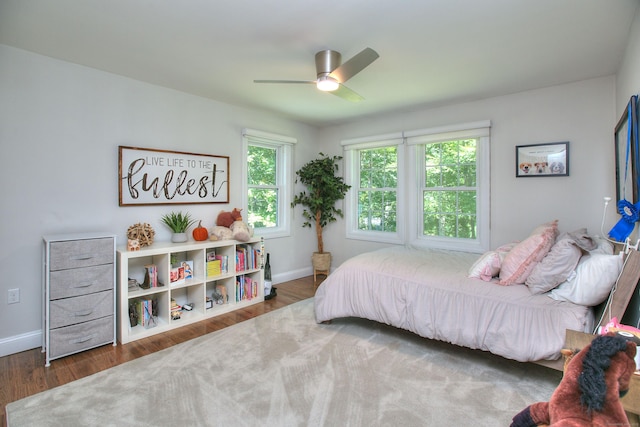 bedroom featuring ceiling fan, baseboards, and dark wood-type flooring