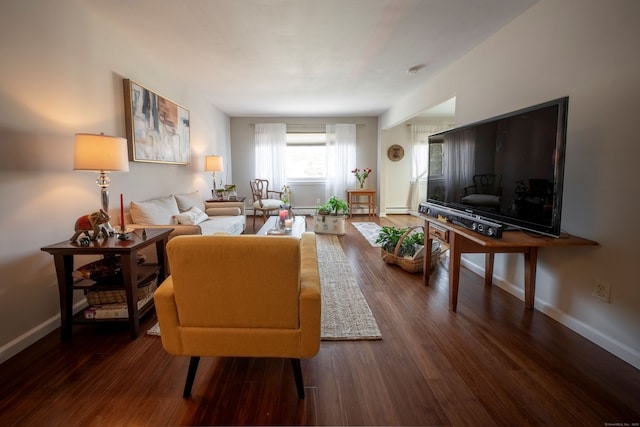 living room featuring baseboard heating, dark wood finished floors, and baseboards