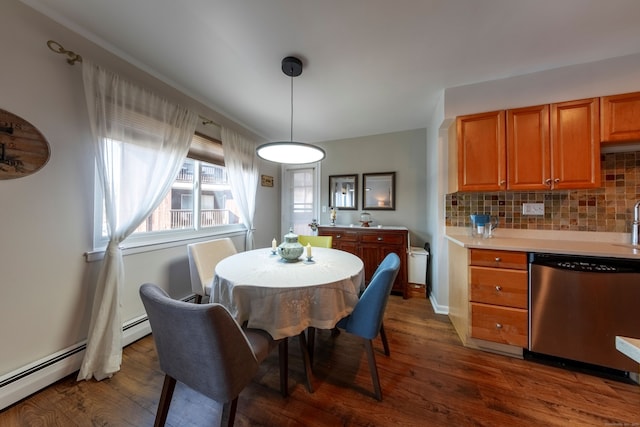 dining room with dark wood-type flooring, a baseboard radiator, and baseboards