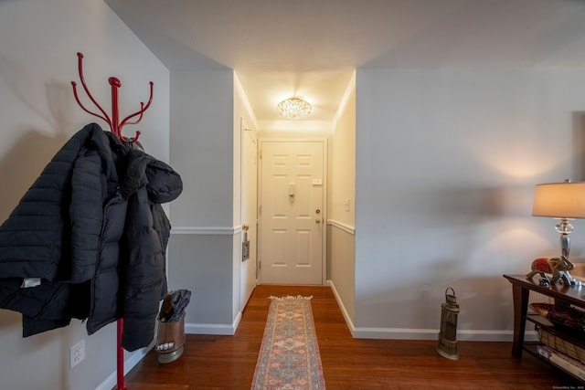 foyer entrance featuring baseboards and wood finished floors