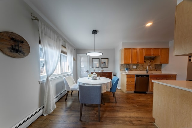 dining room featuring dark wood-style floors, a baseboard heating unit, and recessed lighting