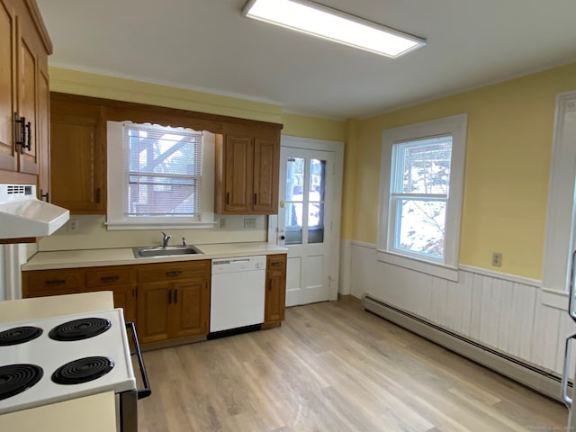 kitchen with a baseboard heating unit, white appliances, brown cabinetry, and a sink