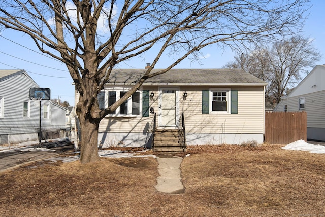 view of front of house with entry steps and fence