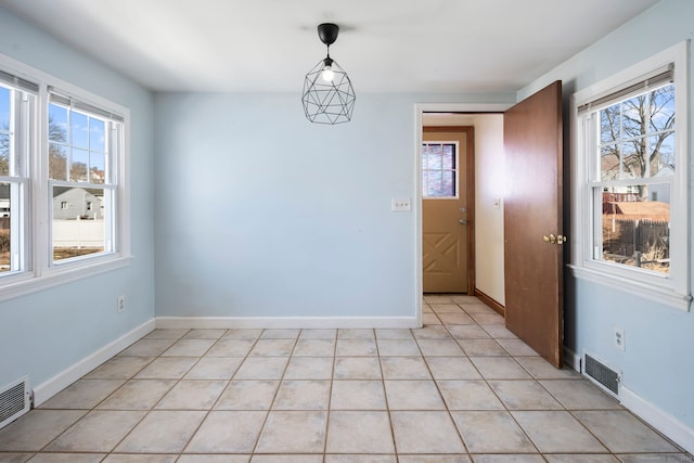 unfurnished dining area with light tile patterned floors, baseboards, and visible vents