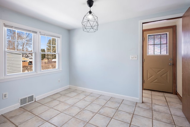 unfurnished dining area featuring light tile patterned flooring, visible vents, and baseboards