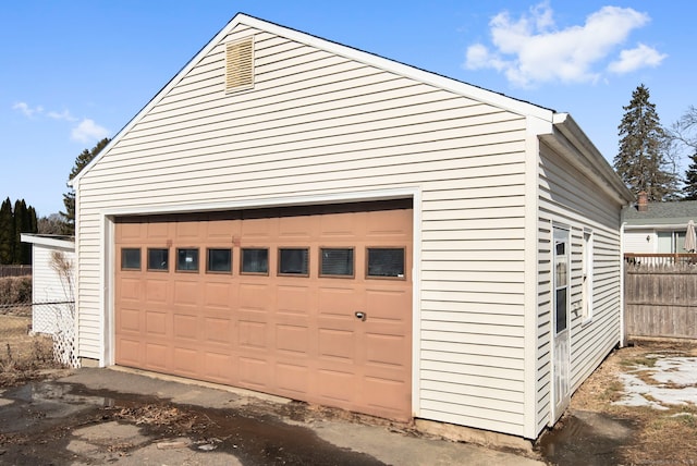 detached garage featuring fence