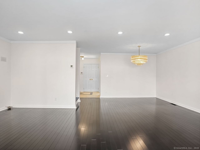 unfurnished living room featuring ornamental molding, dark wood finished floors, and baseboards