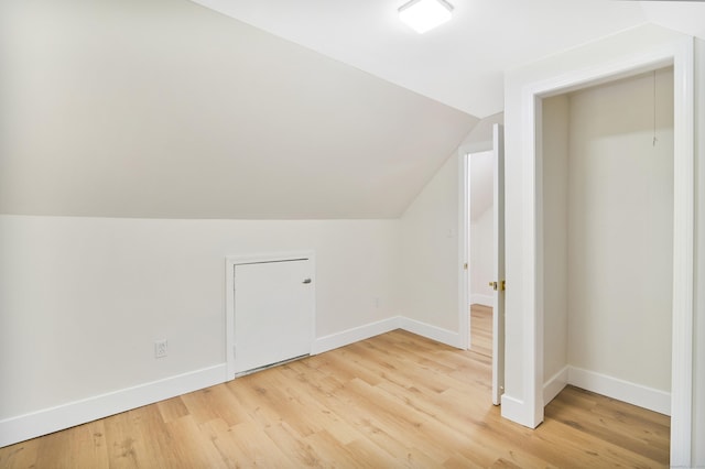 bonus room featuring lofted ceiling, baseboards, and wood finished floors